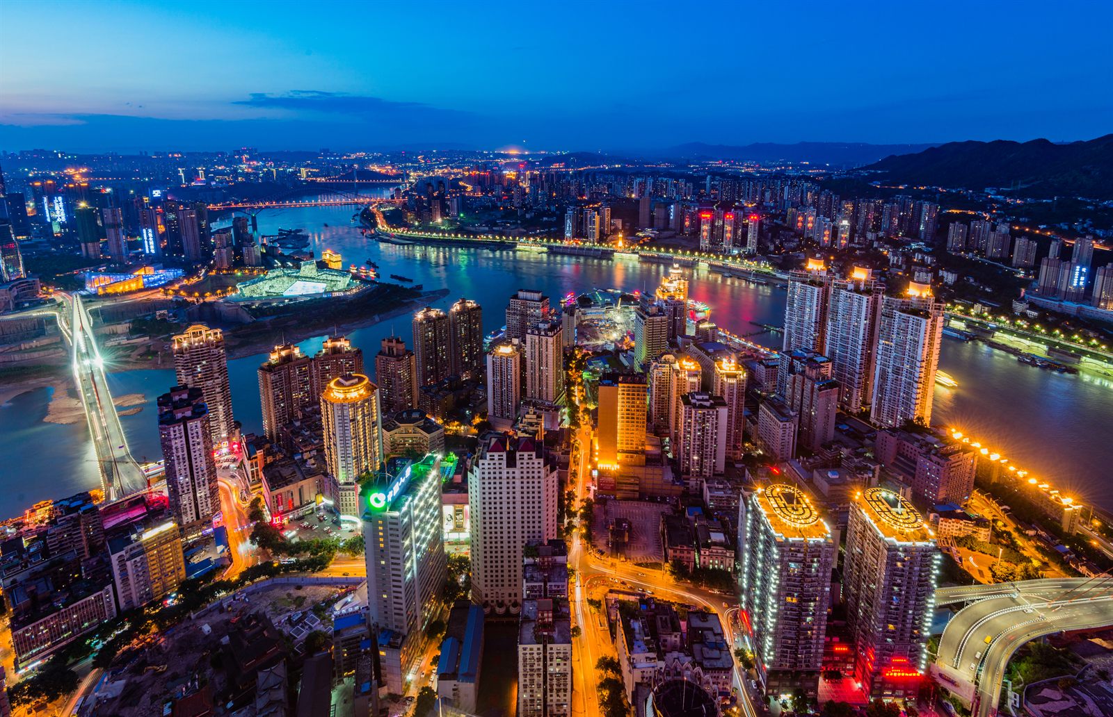 Chongqing skyline lit up at night where two rivers meet